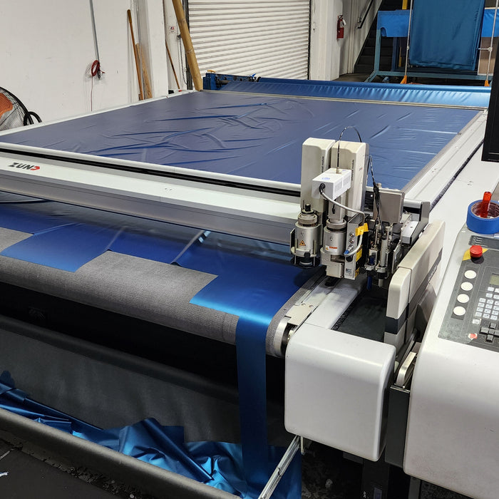 Factory photo of a ZUND cutting table setup to cut patterns for waterbed